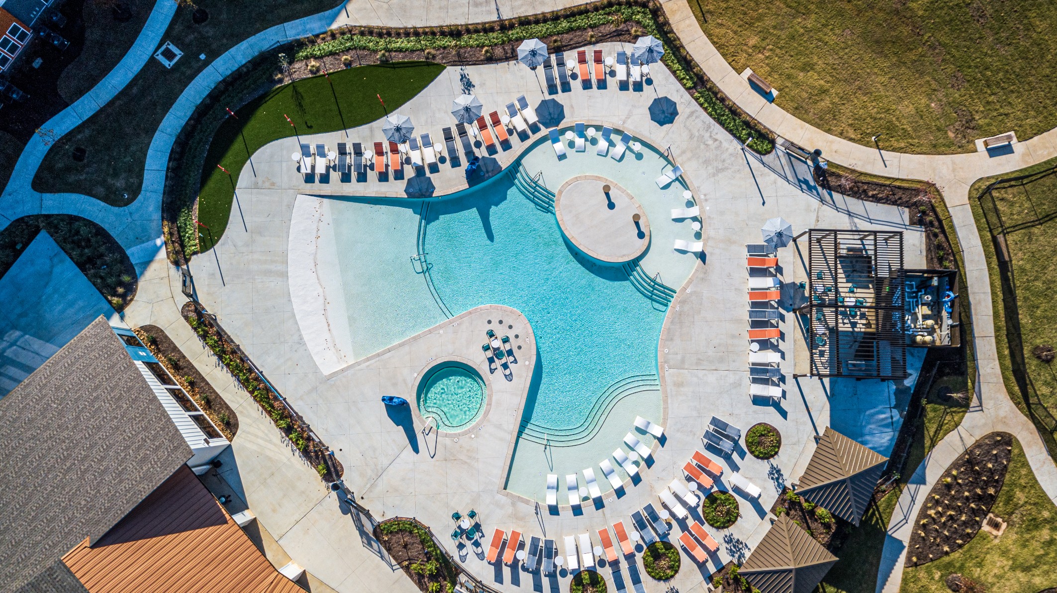 Aerial view of the resort style swimming pool and hot tub at The Tusk