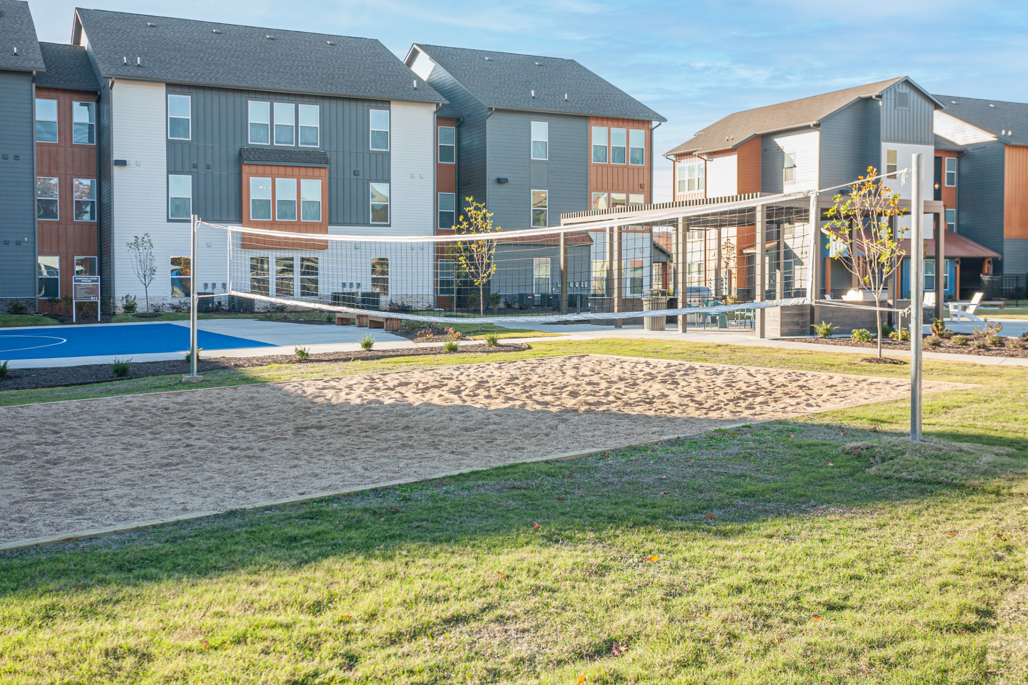 Outdoor sand volleyball court and basketball court at The Tusk