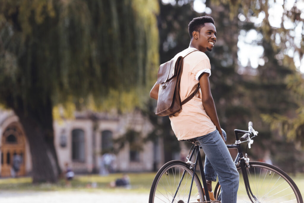 student on bicycle at university campus